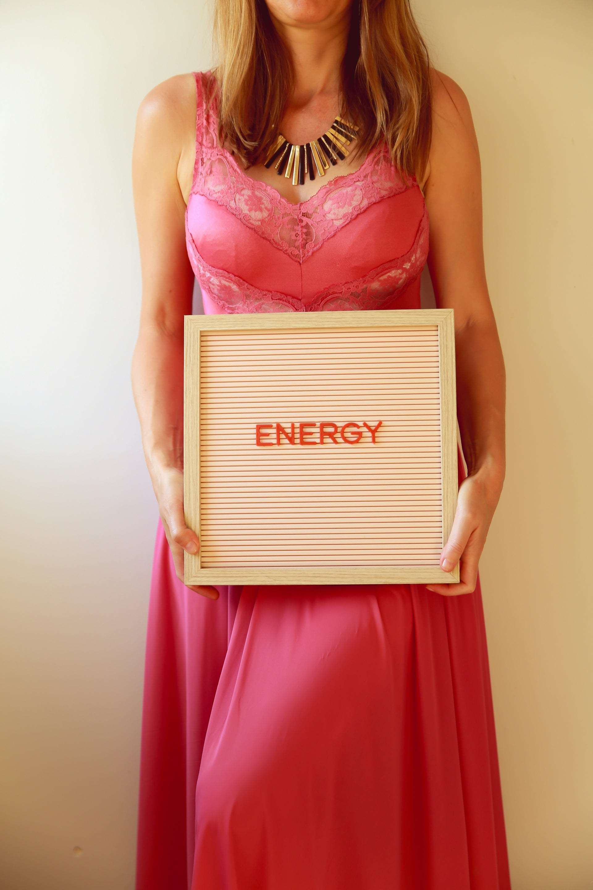 Woman holds a sign that says energy.